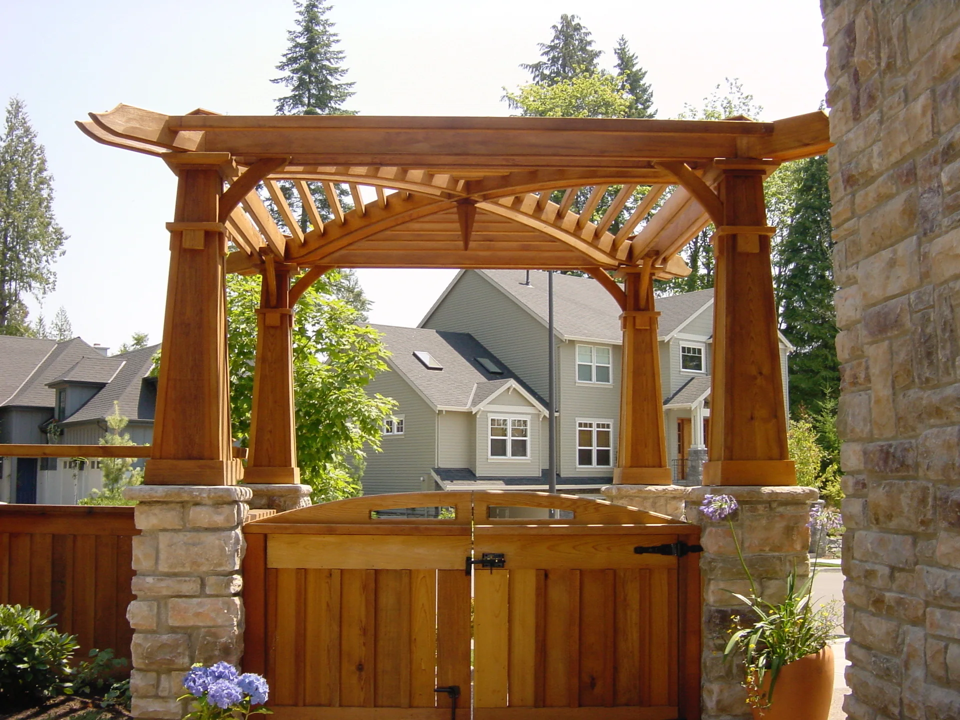Custom cedar pergola with stone columns