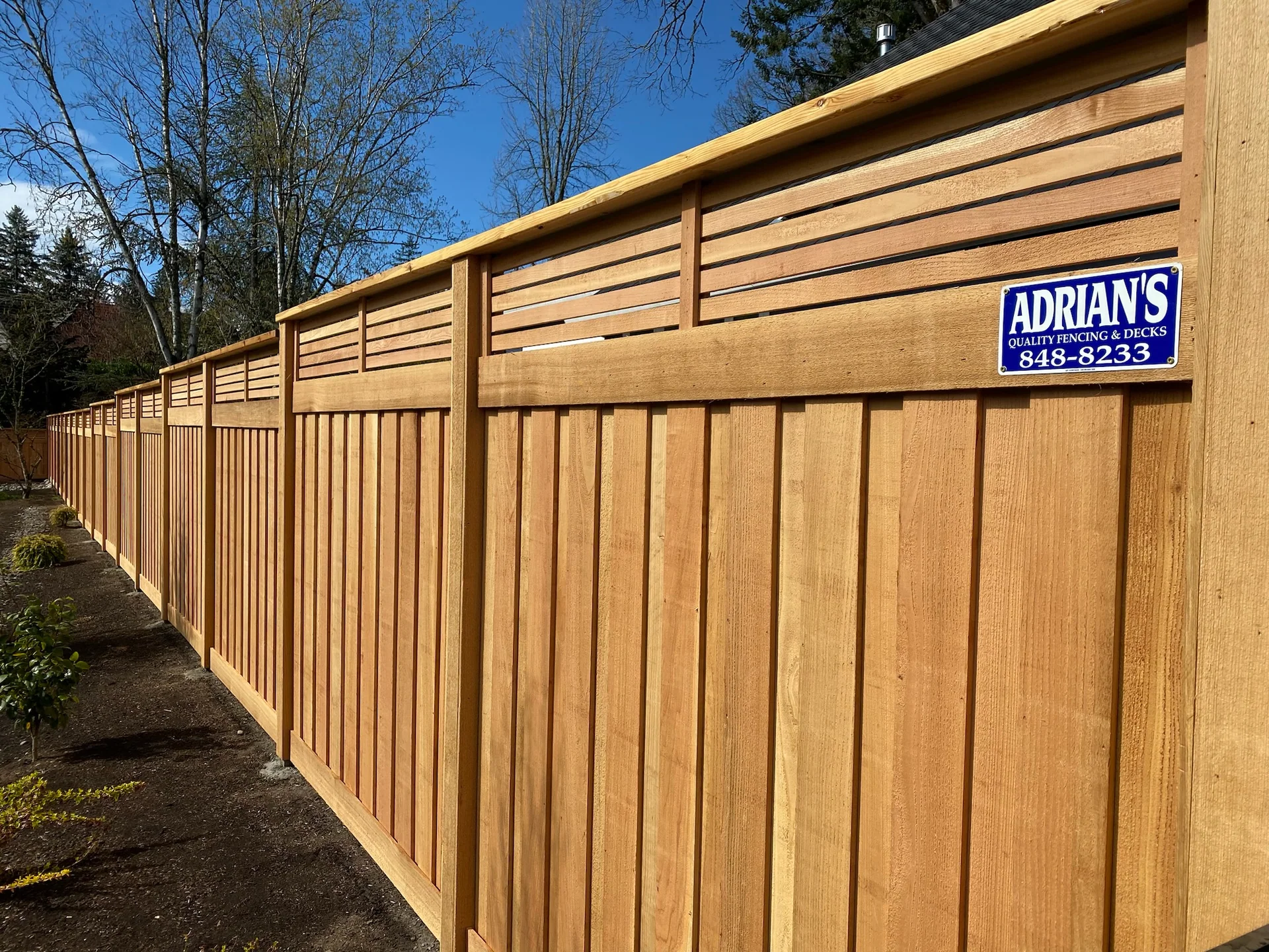 Completed picture-frame cedar fence with horizontal lattice