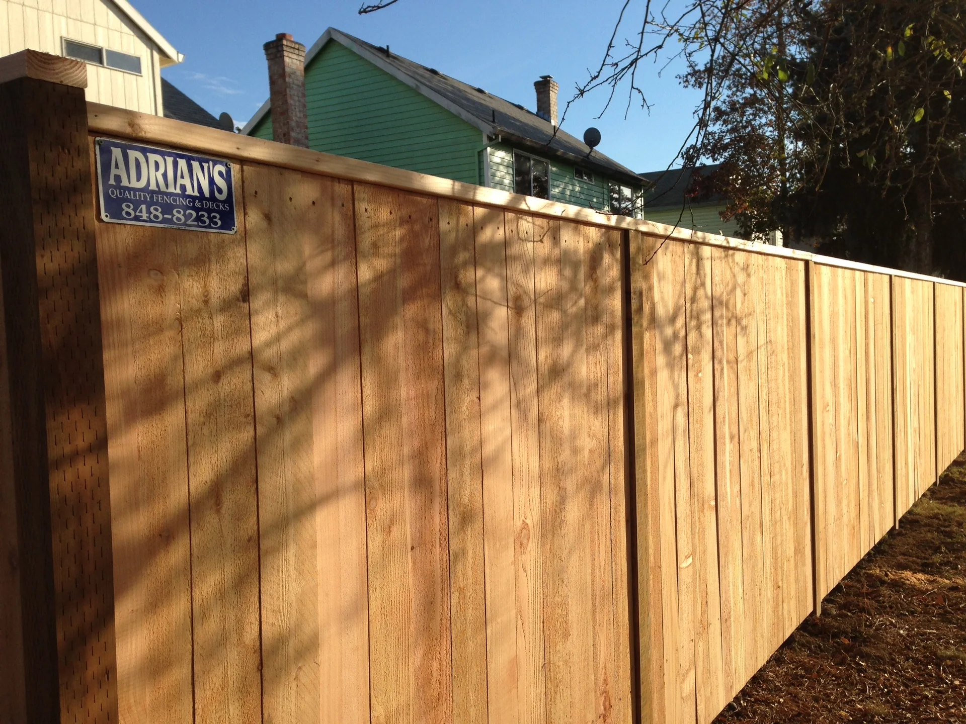 Completed solid cedar privacy fence running along a Portland-area property